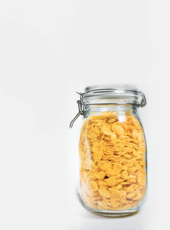 Corn flakes in jar on white backgroundの写真素材
