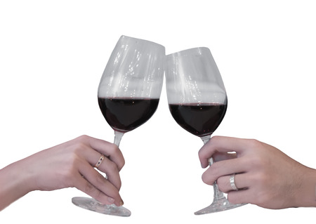 Close-up partial view of two friends clinking transparent glasses of red wine. ready to use and work path. isolated on white backgroundの写真素材