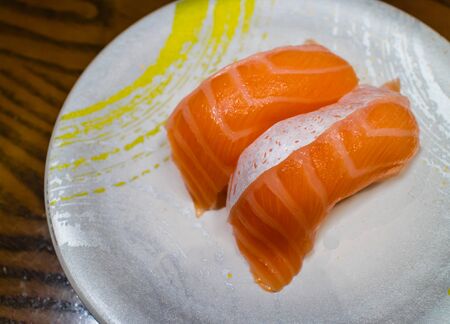 Salmon sushi or salmon nigiri in Japanese style fresh serve on white plateの写真素材