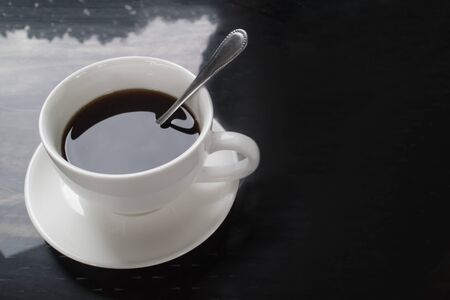 Top view of hot coffee in white ceramic cup, black and white toneの写真素材