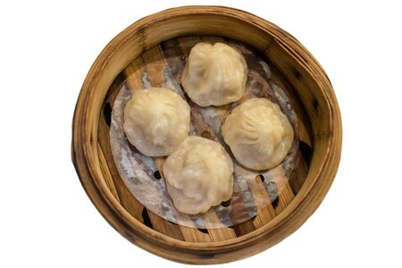 Top view of  Xiao Long Pao in small bamboo steaming basket, Type of Chinese steamed bun filled with lobster, crab meat and soup inside. isolated on whiteの写真素材