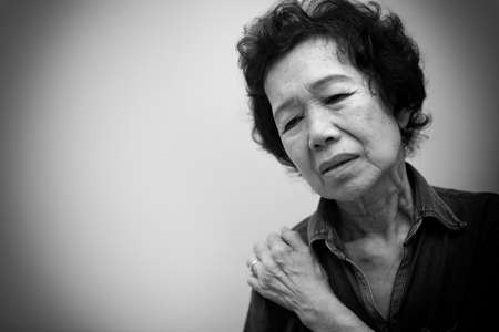 Asian young woman drinking a fresh white paper cup of water or other beverage. Black and white toneの写真素材