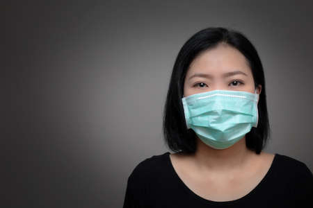 Portrait of Asian woman sneezing from VIRUS COVID-19 or epidemic disease. Health promotion concept.の写真素材