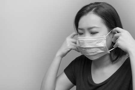 Portrait of Asian woman sneezing from VIRUS COVID-19 or epidemic disease. Health promotion concept.の写真素材