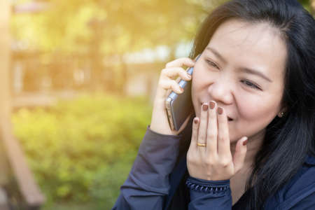 Portrait of Asian woman sneezing from VIRUS COVID-19 or epidemic disease. Health promotion concept.の写真素材