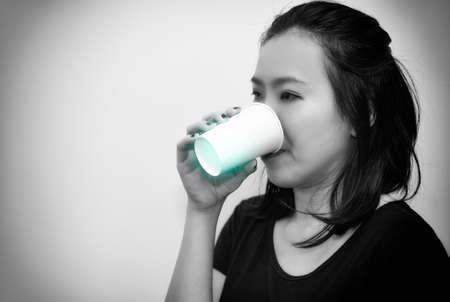 Portrait of Asian woman sneezing from VIRUS COVID-19 or epidemic disease. Health promotion concept.の写真素材