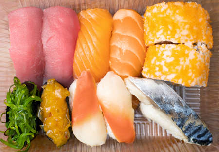 Variety of sushi in plastic box for delivery service. Food delivery concept. Japanese traditional foodの写真素材