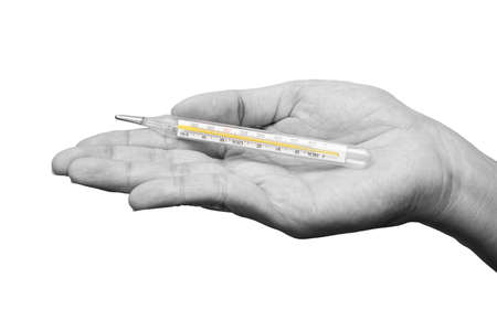 Closeup of hand holding clinical thermometer for checking temperature. Black and white tone. Diagnosis and test COVID-19 or Flu.の写真素材