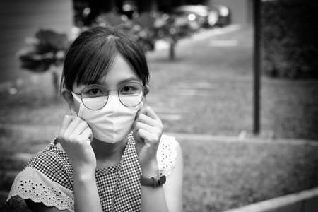 Portrait of Asian woman using mask for protecting COVID-19 or epidemic disease, when go outside.の写真素材