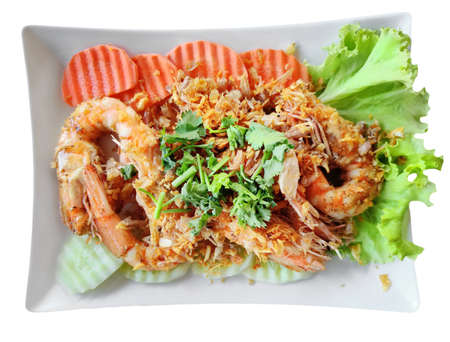 Stir Fried Shrimp with Garlic and Pepper, serving with fresh carrot and cucumber and sprinkle with coriander. Traditional Thai Foodの写真素材