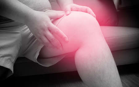 Fatty man suffering from pain in knee, Pain In overweight, Health care, total knee replacement. black and white tone with red spot on kneeの写真素材