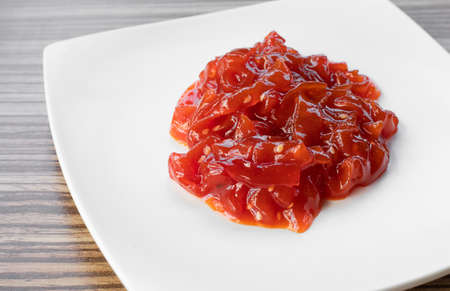 Spicy jellyfish salad with mustard garlic sauce, serving on white plate. Haepari-naengchae, a side dish made with salted jellyfish strips Korean traditional food.の写真素材
