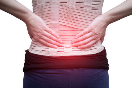 Woman in black t-shirt wearing back support belt for back pain and spinal support. isolated on white background and red spot on 

waist. Medical care conceptの写真素材