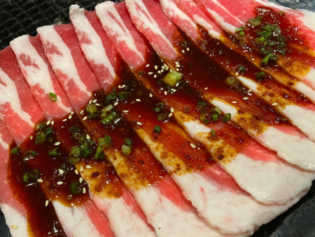 Closed up of sliced raw pork or sliced, meat,  beef for BBQ or yakiniku, Japanese traditional food. Concept of unhealthy foodの写真素材