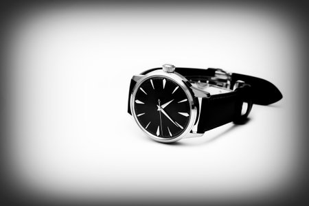Leather Men analog wrist watch isolated on white background with copy space on the left. Black and whit toneの写真素材