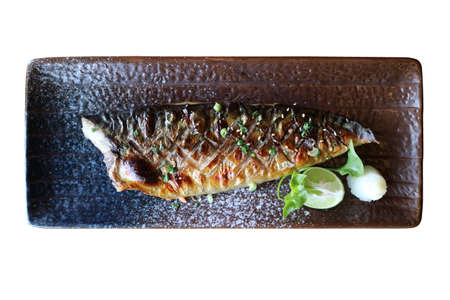 Grilled saba fish with sweet soy sauce set in black ceramic plate. top view and isolated on white background. Traditional Japanese foodの写真素材