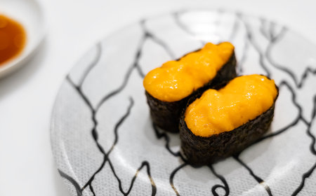 Uni Sushi,  traditional food in Japanese Restaurant. Uni sea urchin sushi japanese cuisine in ceramic plate.の写真素材