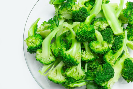 Top view of raw broccoli florets on glass plate. Healthy green organic ready for cookingの写真素材