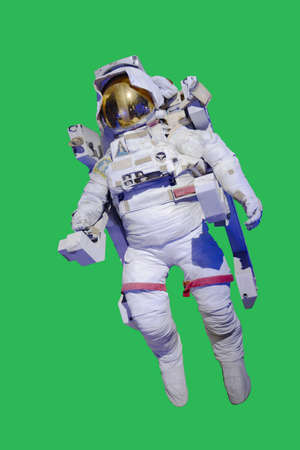 Floating astronaut isolated with green background.の写真素材
