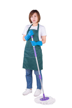 Young Asian housewife holding mop stand on white backgroundの写真素材