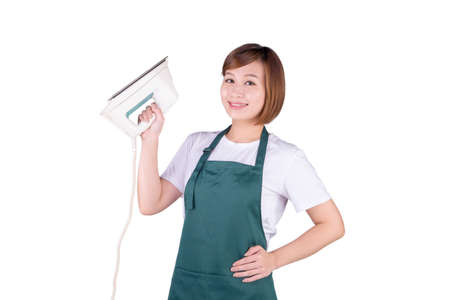 Young Asian housewife in apron hold an ironの写真素材