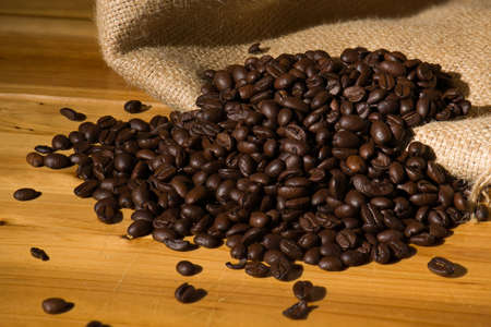 Fresh Roasted Coffee beans on wooden background.の写真素材