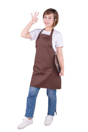 Smiling woman in apron showing OK on white backgroundの写真素材
