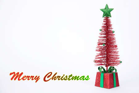 Red Christmas tree with greeting on white backgroundの写真素材