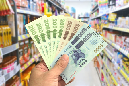 Taipei, Taiwan-Oct 11, 2021: Man's hand hold the Quintuple Stimulus Voucher in a grocery store.のeditorial素材