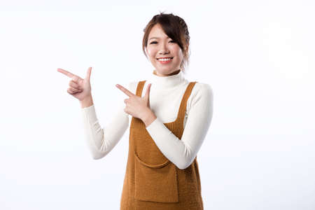 A smiling young girl demonstrate something isolated on white background.の写真素材