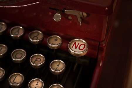 Close up view of a typewriter keyboard. Focus on the key "NO".の写真素材