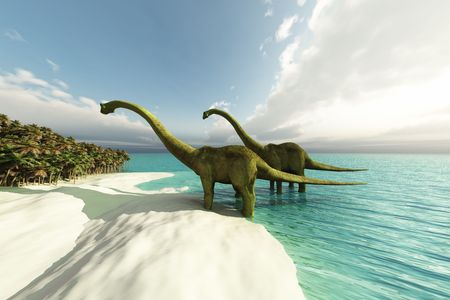 Two Diplodocus dinosaurs wade is shallow waters of a white sand beach.の写真素材