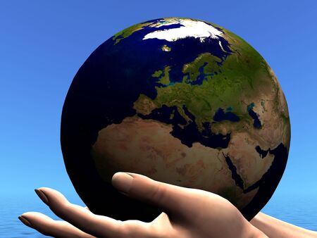 EARTH GLOBE - The planet Earth is held in caring hands.の写真素材