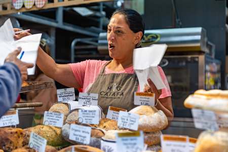 MELBOURNE, AUSTRALIA - APRIL 12, 2024: Female Vendor at the Queen Victoria Marketのeditorial素材