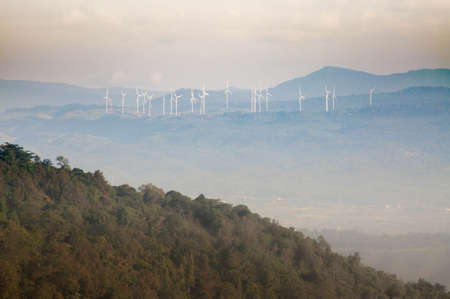 The windmill on the top of the mountain in Thailand with pink sky background.の写真素材
