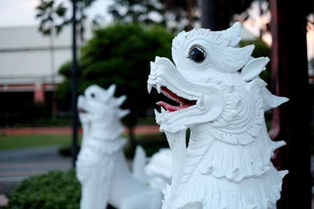 The white Shingha in front of the temple in Thailand