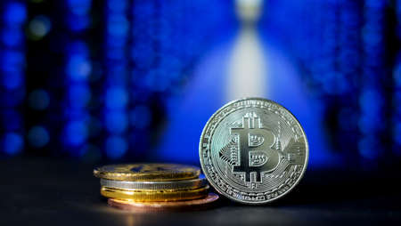 The digital currency coins with blue light bokeh backgroundの写真素材