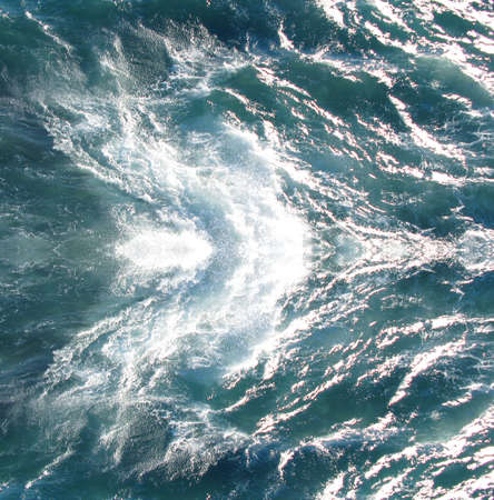 Sea texture, blue water, wave, white foam and bubbles. Sea background, Summer texture. South sea.の写真素材