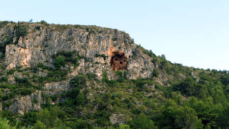 Unusual caves in the rock above. Four caves. Mountains of Spain, Alicanteの写真素材