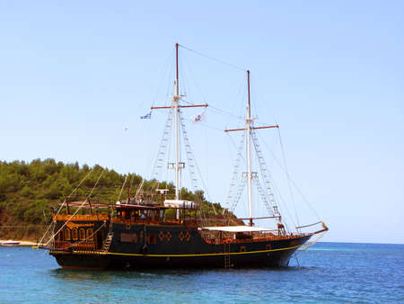 Beautiful vintage retro sailing ship sails on the sea against the blue skyの写真素材