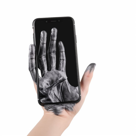 Real hand is drawn into smartphone, hand becomes mechanical, transition of reality into virtual worldの素材