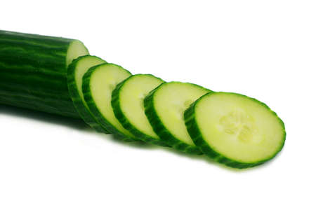 sliced fresh cucumber isolated on white backgroundの写真素材