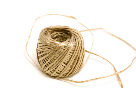 skein of golden thread on whiteの写真素材