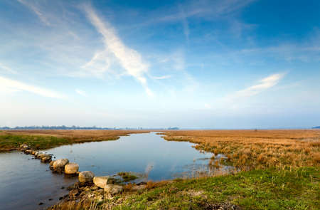 wild lake and blue sky with light white cloudsの写真素材