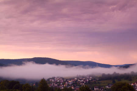 small town in Bavarian mountains at sunriseの写真素材