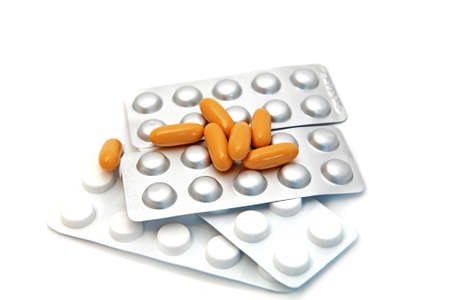 different pills on white background