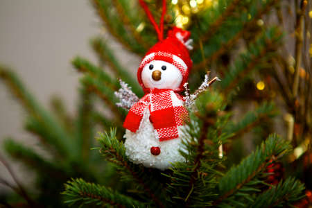 cute snowman toy on Christmas tree during holidaysの写真素材