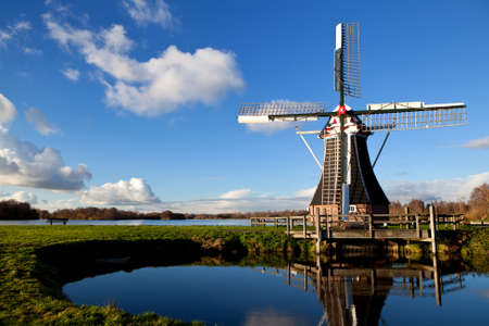 charming Dutch windmill over blue skyの写真素材