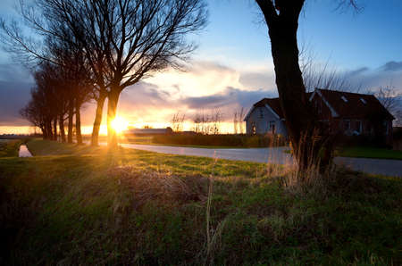 Dutch typical farm house at dramatic sunriseの写真素材
