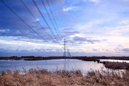 high-voltage electric line over swamp in Groningenの写真素材